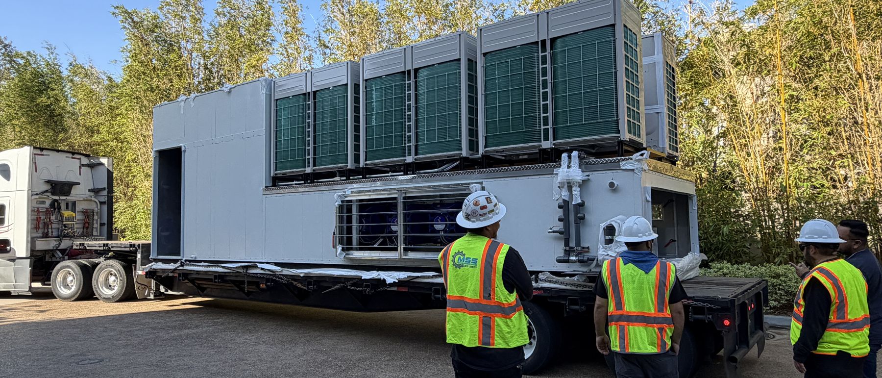 Engineers inspecting a delivered replacement unit at the jobsite