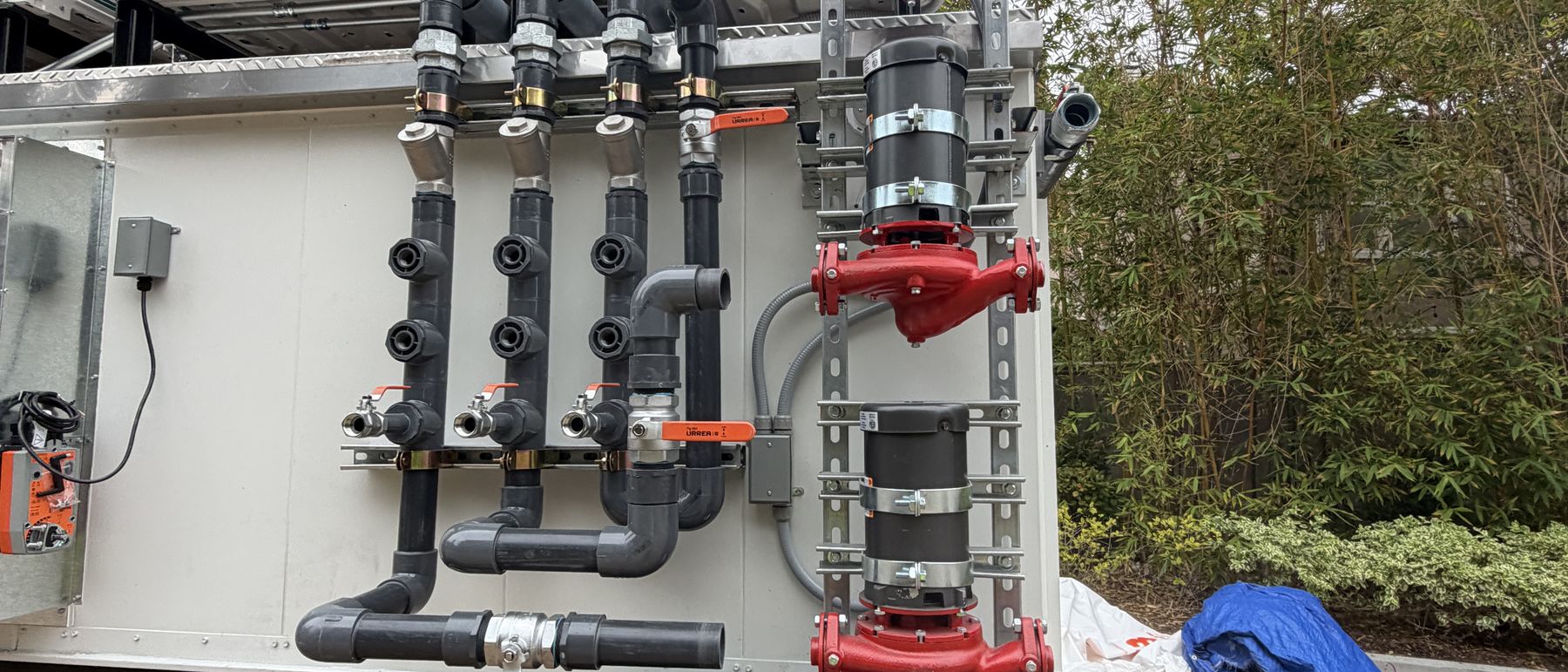 Factory piping header assembly with service valves on a replacement unit