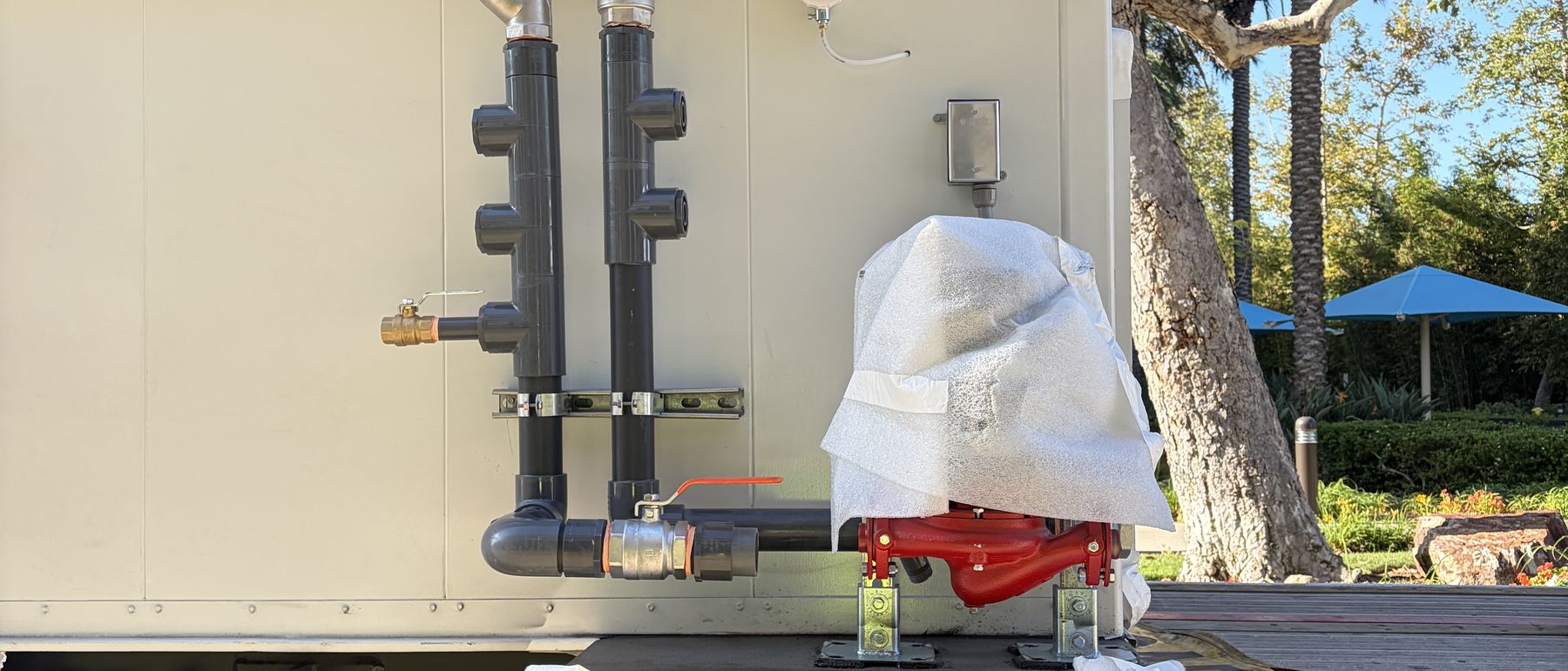 Factory-made piping headers and service valves on a replacement unit