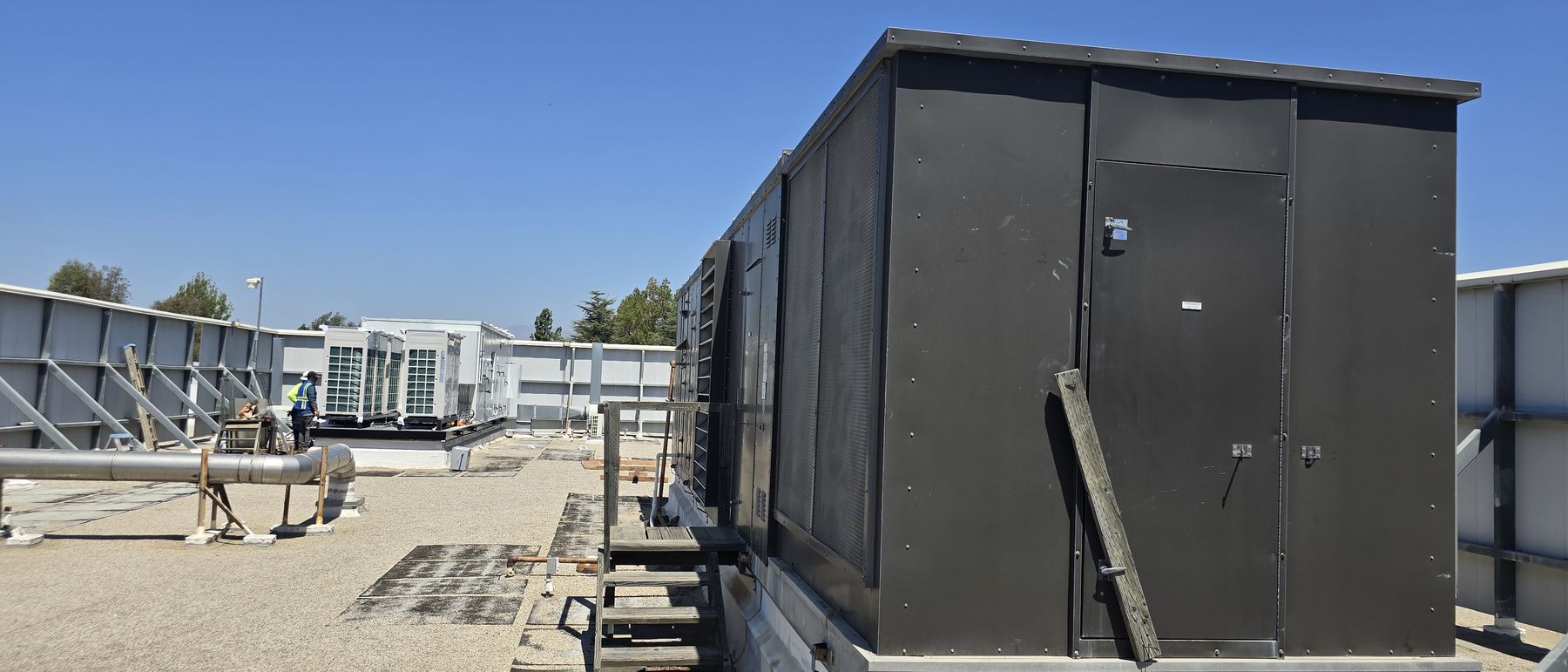 Completed all-electric multi-zone replacement unit set on an occupied building roof