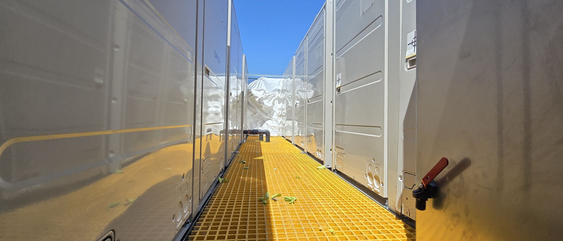 Service walkway between installed units on a completed roof