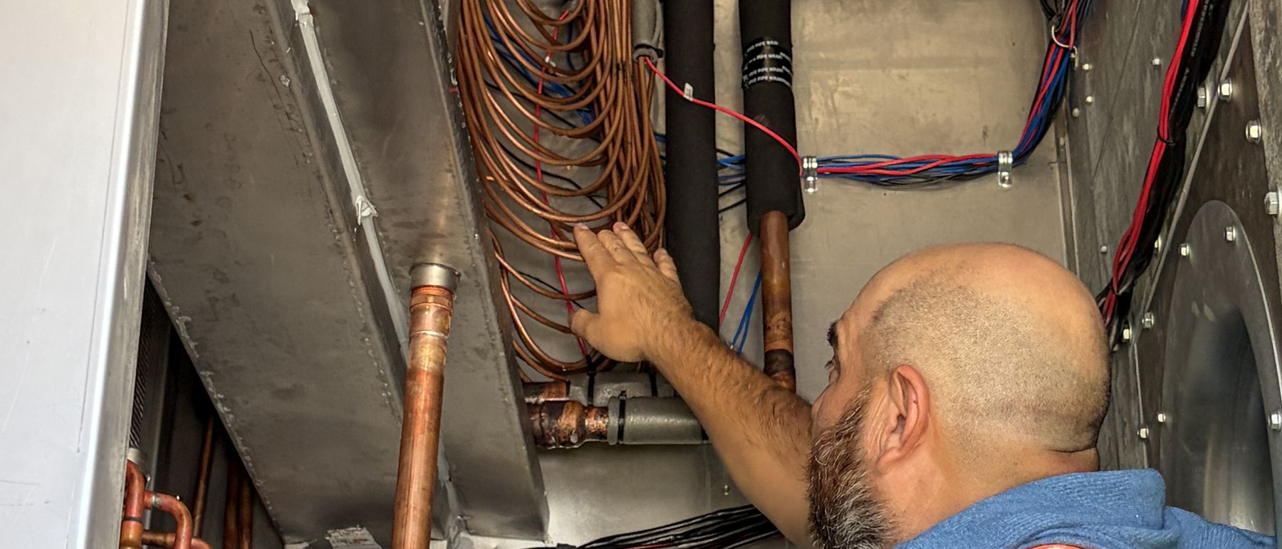 Copper headers and power conductors routed together inside a factory-built unit