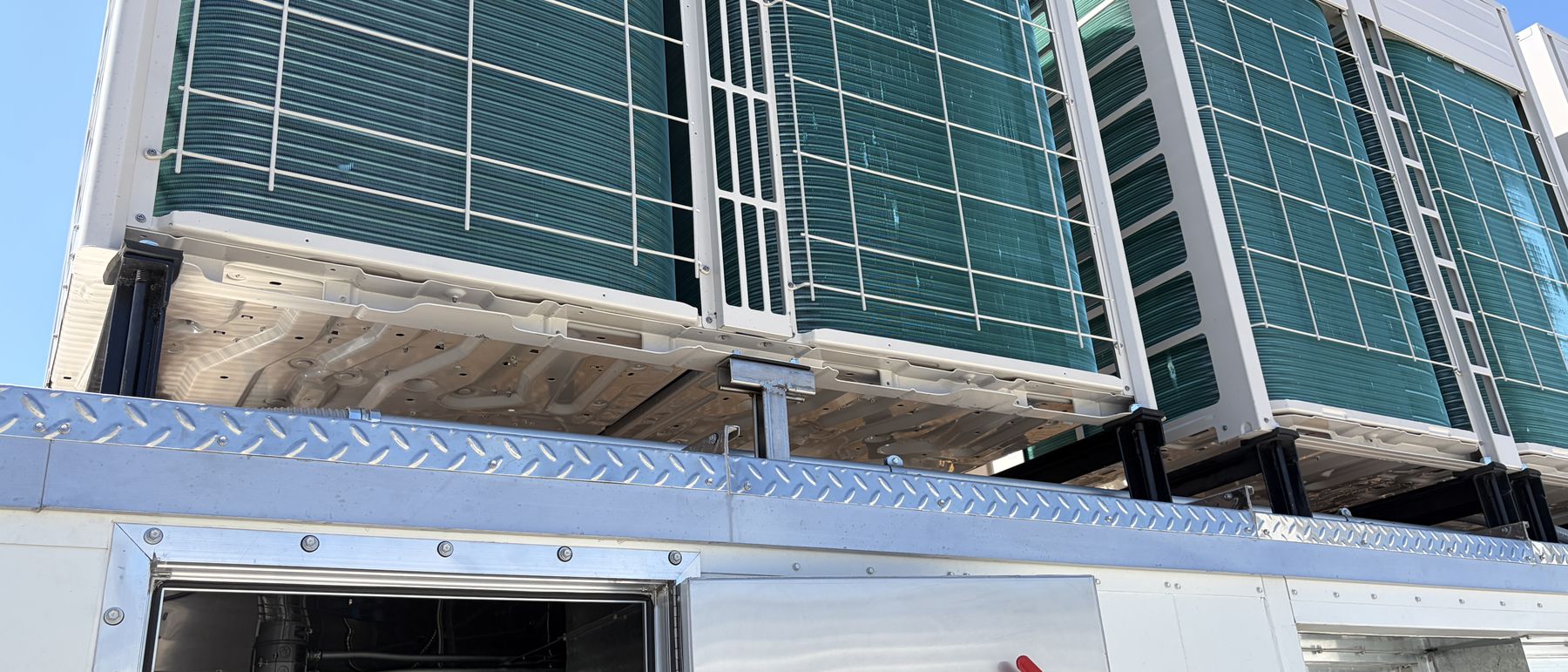 Replacement unit with access door open showing the coil face and internal sections
