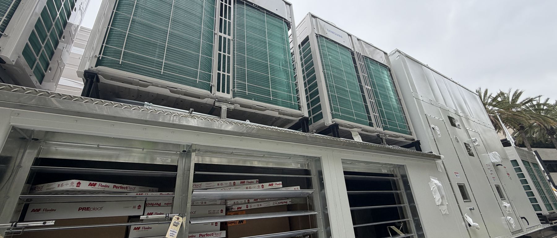 Several all-electric replacement units on a flatbed ready for a phased rooftop changeout