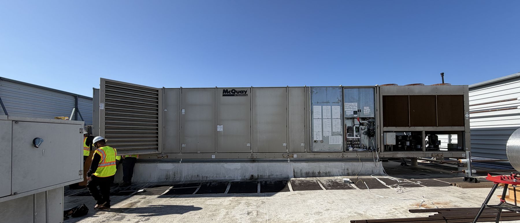 Legacy gas-electric rooftop unit at end of useful life on an occupied building roof