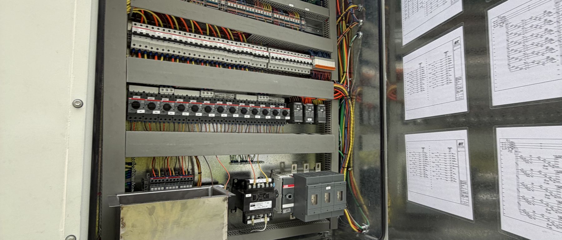 Factory control panel with labelled boards and landed terminal blocks