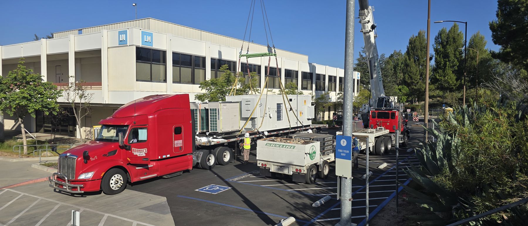 Replacement multi-zone unit arriving by truck at an occupied campus building